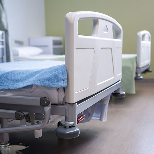 empty hospital beds in hospital room