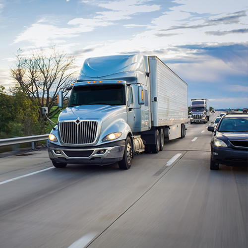 Semi truck and cars on freeway